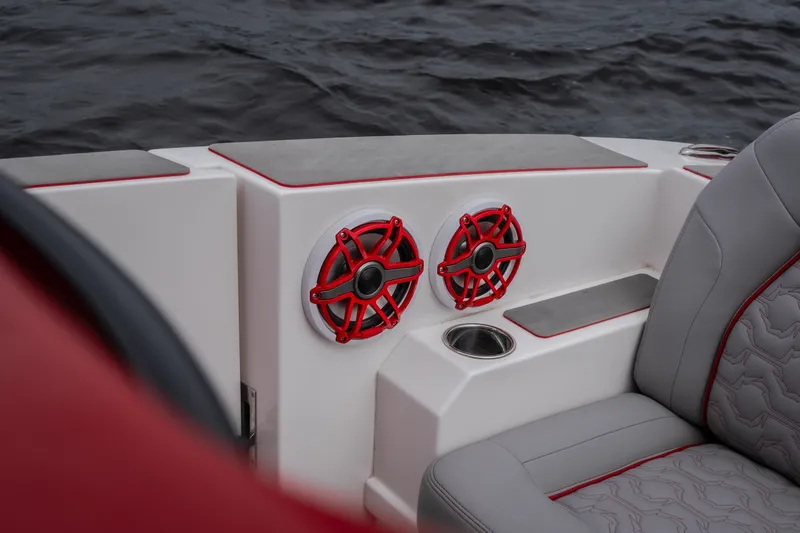 Slide: The Image of 2024 Fountain 38 SCX boat interior with red speakers and gray seating. - 38
