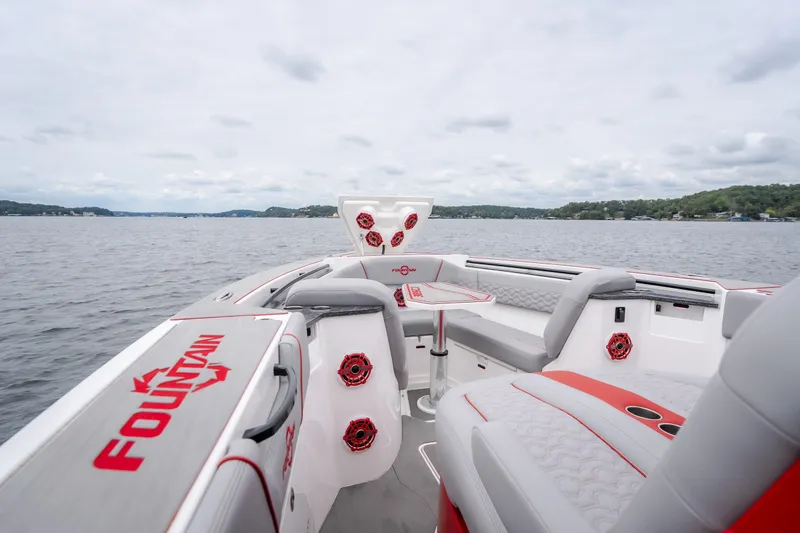 Slide: The Image of 2024 Fountain 38 SCX boat interior with red accents on a calm lake. - 66