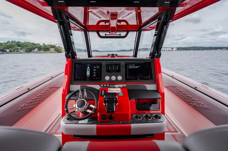 Slide: The Image of 2024 Fountain 38 SCX boat dashboard with modern controls and scenic water view. - 61
