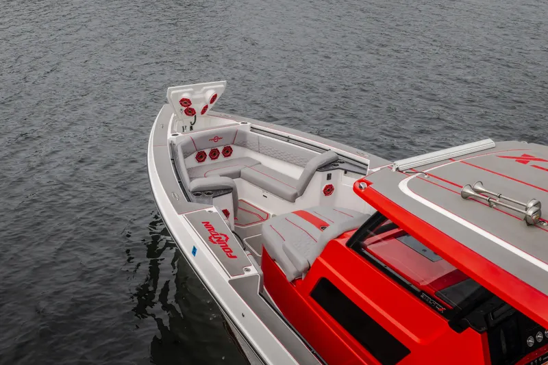 Slide: The Image of 2024 Fountain 38 SCX boat with sleek red and gray interior on calm water. - 10