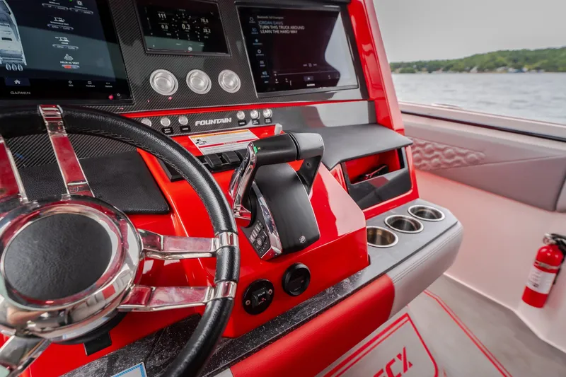 Slide: The Image of 2024 Fountain 38 SCX boat dashboard with steering wheel and control panel. - 63