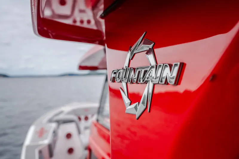 Slide: The Image of 2024 Fountain 38 SCX boat, red exterior, close-up of logo on water. - 40
