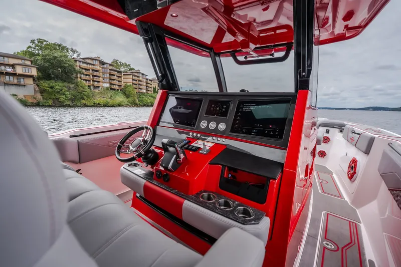 Slide: The Image of 2024 Fountain 38 SCX boat interior with red dashboard and modern controls. - 48