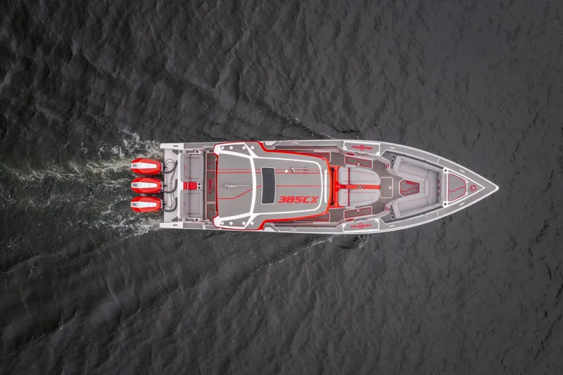 Slide: The Image of Top view of 2024 Fountain 38 SCX boat cruising on water with triple engines. - 3