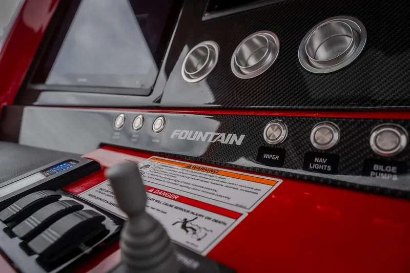 Slide: The Image of 2024 Fountain 38 SCX dashboard with controls and carbon fiber accents. - 47