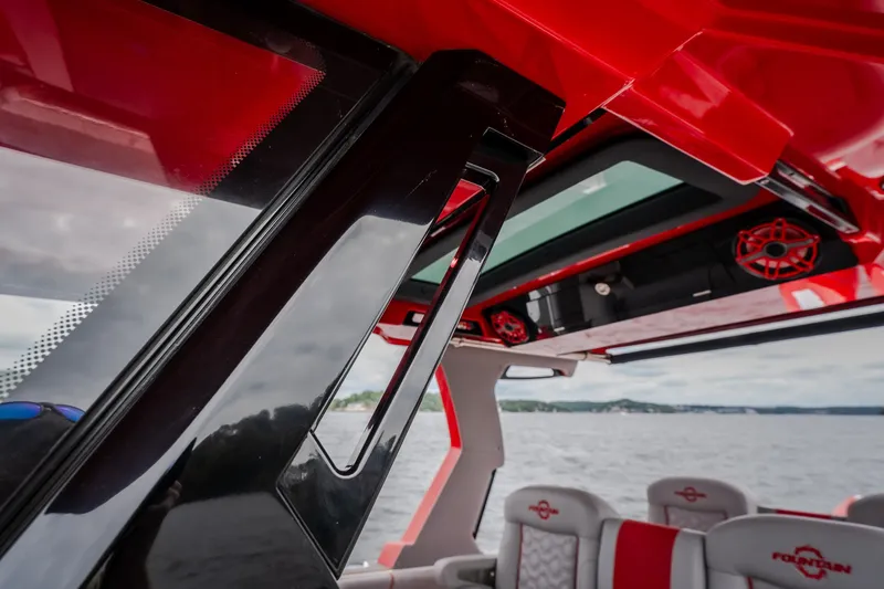 Slide: The Image of Interior view of 2024 Fountain 38 SCX boat with red accents and seating. - 36
