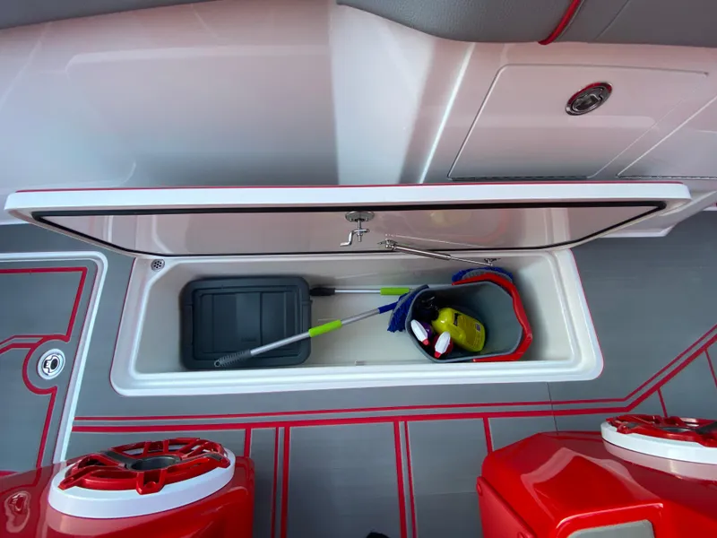 Slide: The Image of 2024 Fountain 38 SCX boat storage compartment with cleaning supplies and tools. - 41