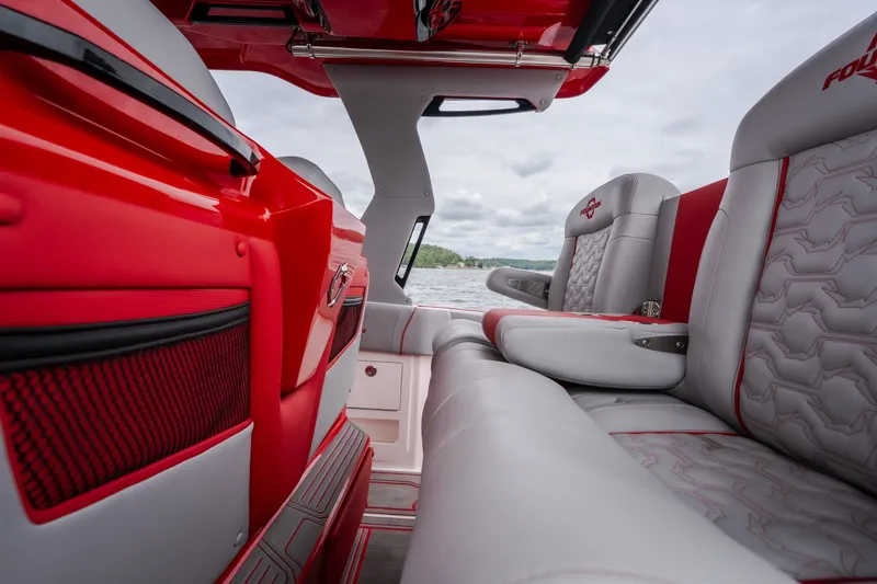 Slide: The Image of Interior of 2024 Fountain 38 SCX boat with red and gray seating. - 34