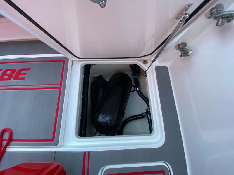 Slide: The Image of 2024 Fountain 38 SCX boat storage compartment with equipment and red accents. - 42