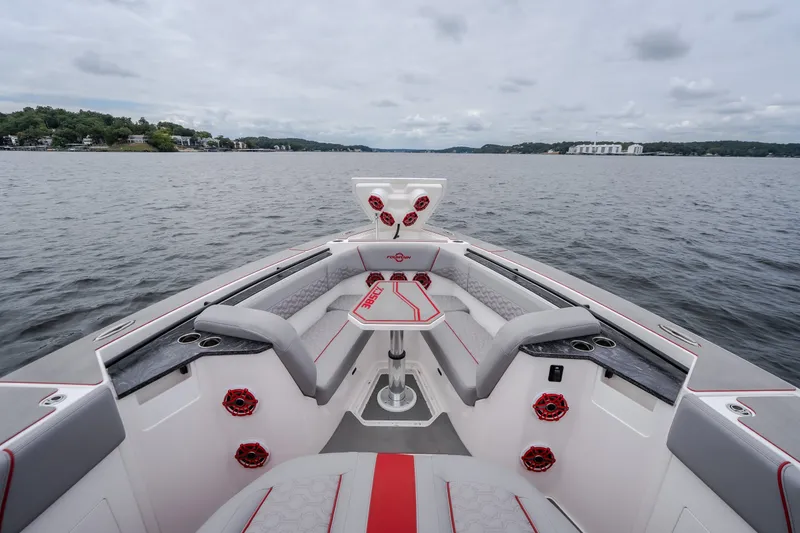 Slide: The Image of 2024 Fountain 38 SCX boat interior with red accents on a lake. - 71