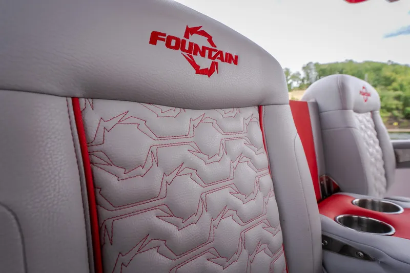 Slide: The Image of 2024 Fountain 38 SCX boat seats with red stitching and logo detail. - 44