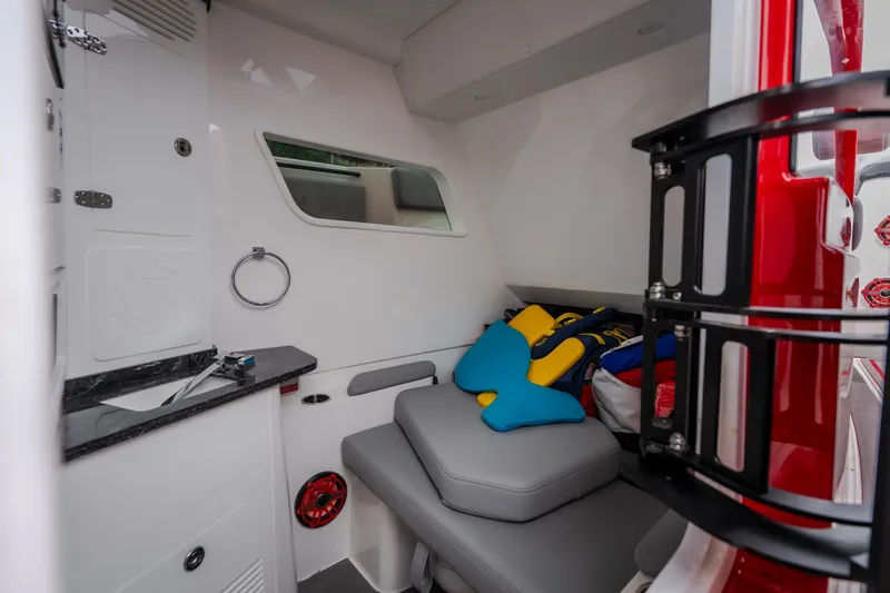 Slide: The Image of 2024 Fountain 38 SCX cabin interior with seating, life jackets, and storage. - 53