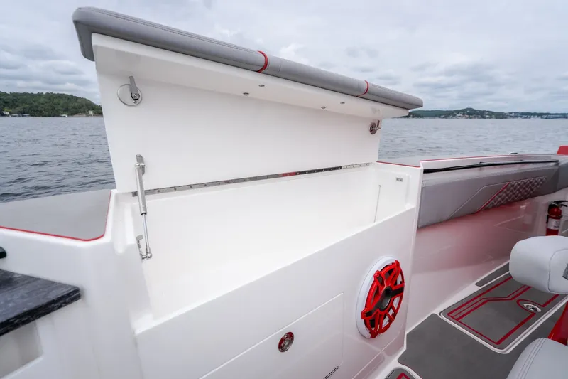 Slide: The Image of 2024 Fountain 38 SCX boat interior with open storage compartment and red speaker. - 70