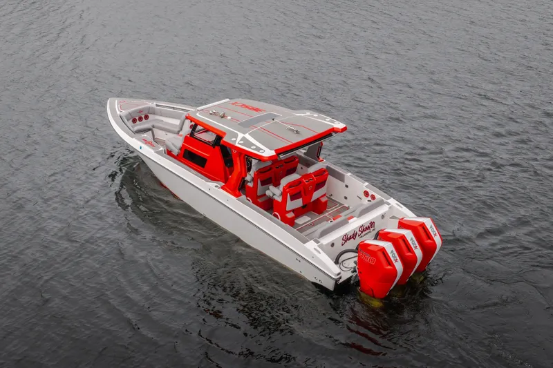 Slide: The Image of 2024 Fountain 38 SCX boat with red accents and triple outboard engines on water. - 6