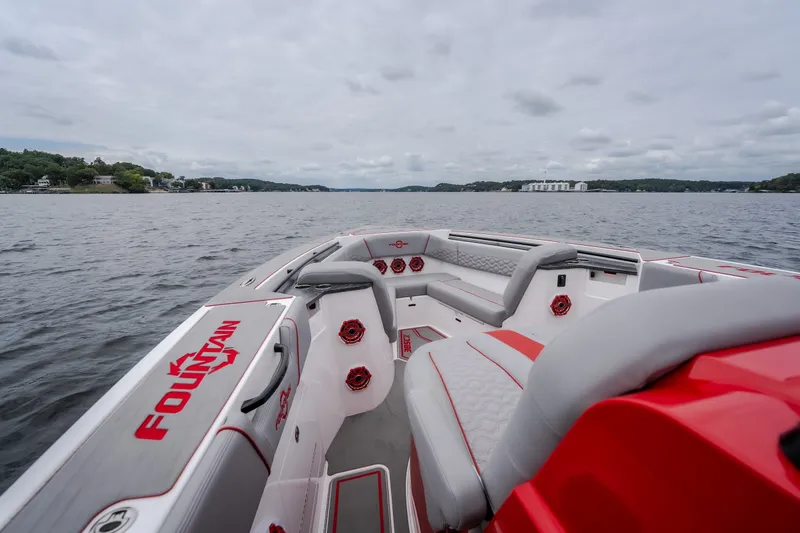 Slide: The Image of 2024 Fountain 38 SCX boat interior with red accents on a lake. - 74