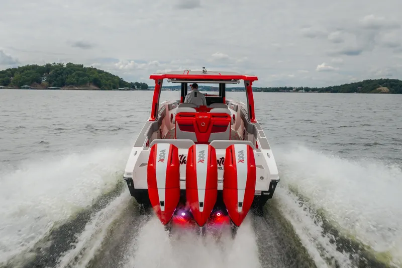 Slide: The Image of 2024 Fountain 38 SCX boat cruising on a lake with powerful engines. - 83