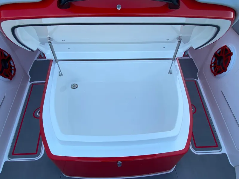 Slide: The Image of 2024 Fountain 38 SCX boat storage compartment, open lid, red and white interior design. - 33