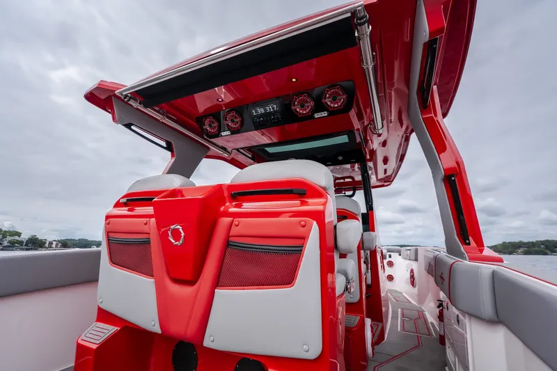 Slide: The Image of 2024 Fountain 38 SCX boat interior with red and white seating, advanced audio system. - 20