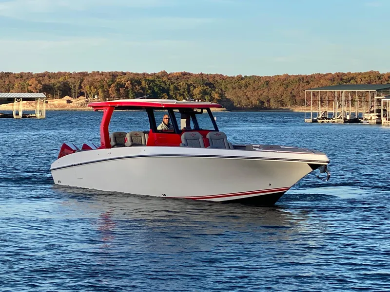 Slide: The Image of 2024 Fountain 38 SCX boat cruising on a lake with a scenic background. - 3