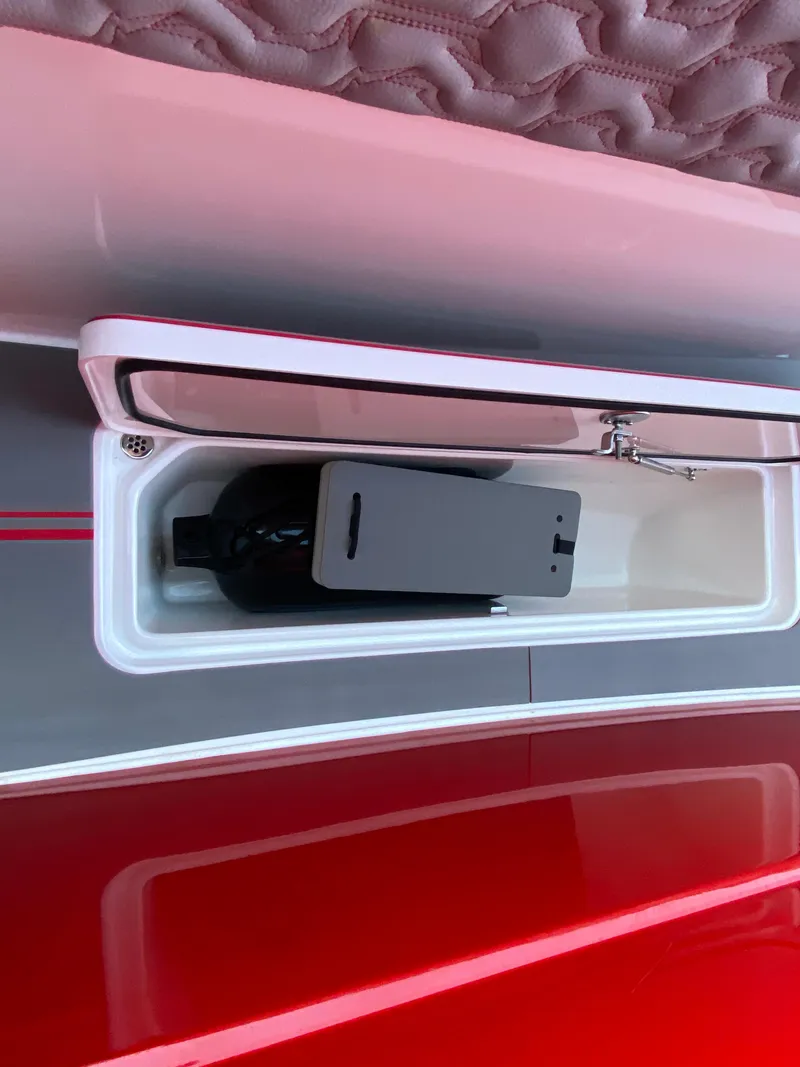 Slide: The Image of 2024 Fountain 38 SCX boat storage compartment with a bottle inside. - 36