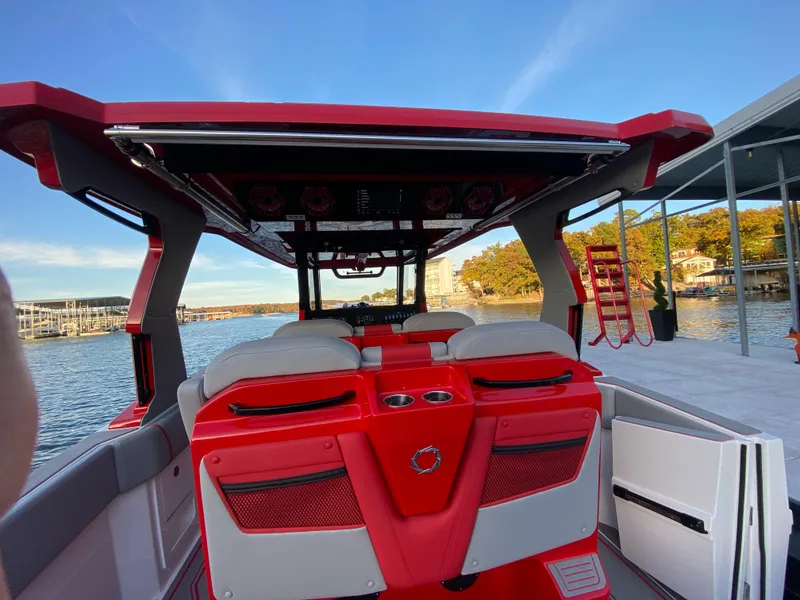 Slide: The Image of 2024 Fountain 38 SCX boat with red and white interior, docked by the water. - 47