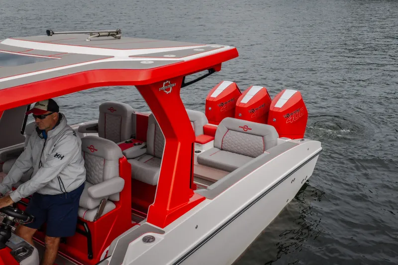 Slide: The Image of 2024 Fountain 38 SCX boat with red accents and triple outboard engines on the water. - 9