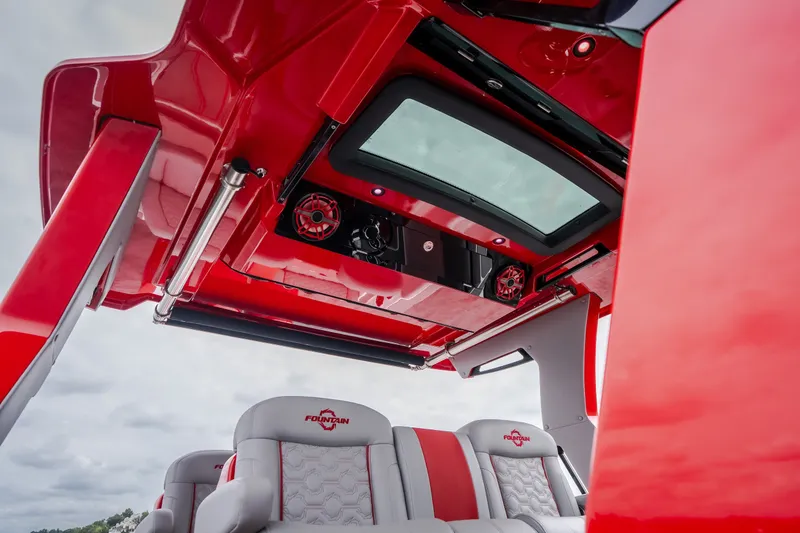 Slide: The Image of 2024 Fountain 38 SCX boat interior with red accents and modern seating design. - 57