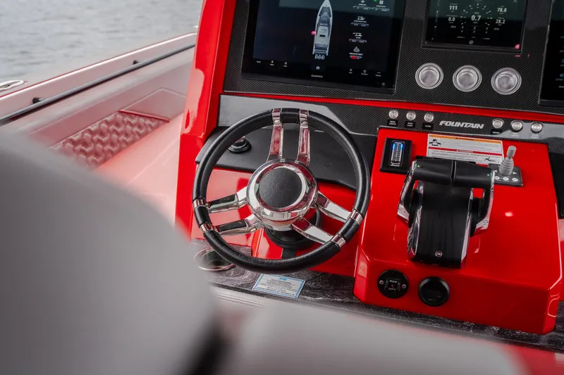 Slide: The Image of 2024 Fountain 38 SCX boat dashboard with steering wheel and control panel. - 62