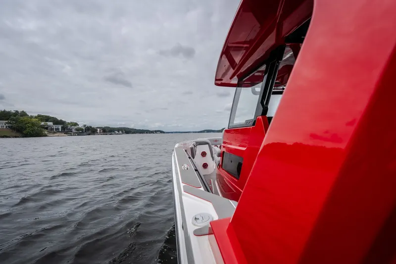 Slide: The Image of 2024 Fountain 38 SCX boat cruising on a lake under cloudy skies. - 39