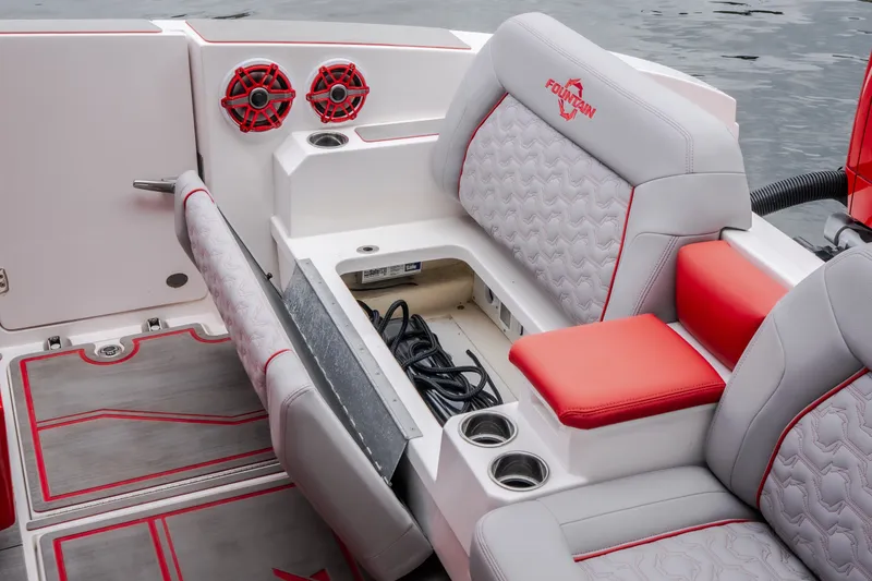 Slide: The Image of 2024 Fountain 38 SCX boat interior with red accents and storage compartment. - 45