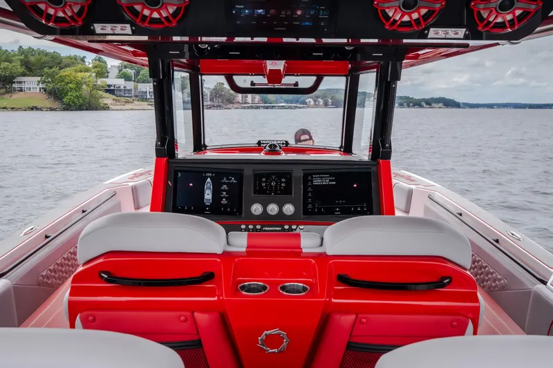 Slide: The Image of Interior view of 2024 Fountain 38 SCX boat with modern dashboard and red accents. - 29