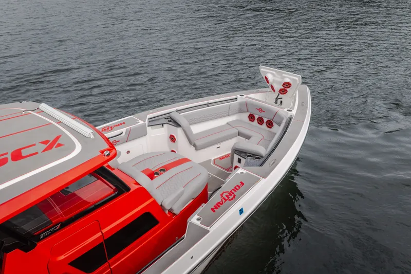 Slide: The Image of 2024 Fountain 38 SCX boat with sleek red and gray design on water. - 12