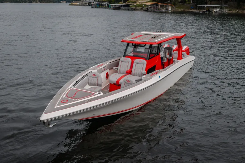Slide: The Image of 2024 Fountain 38 SCX boat with red and white design on a calm lake. - 8
