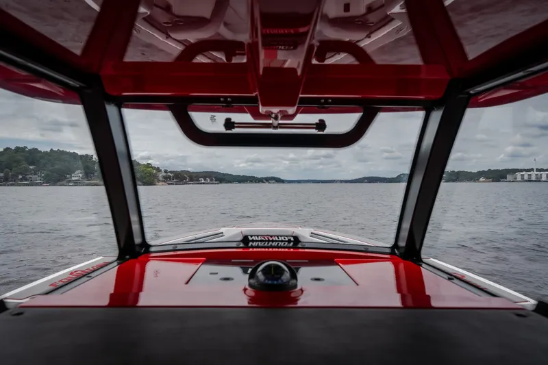 Slide: The Image of Interior view from 2024 Fountain 38 SCX boat, overlooking a scenic lake. - 60
