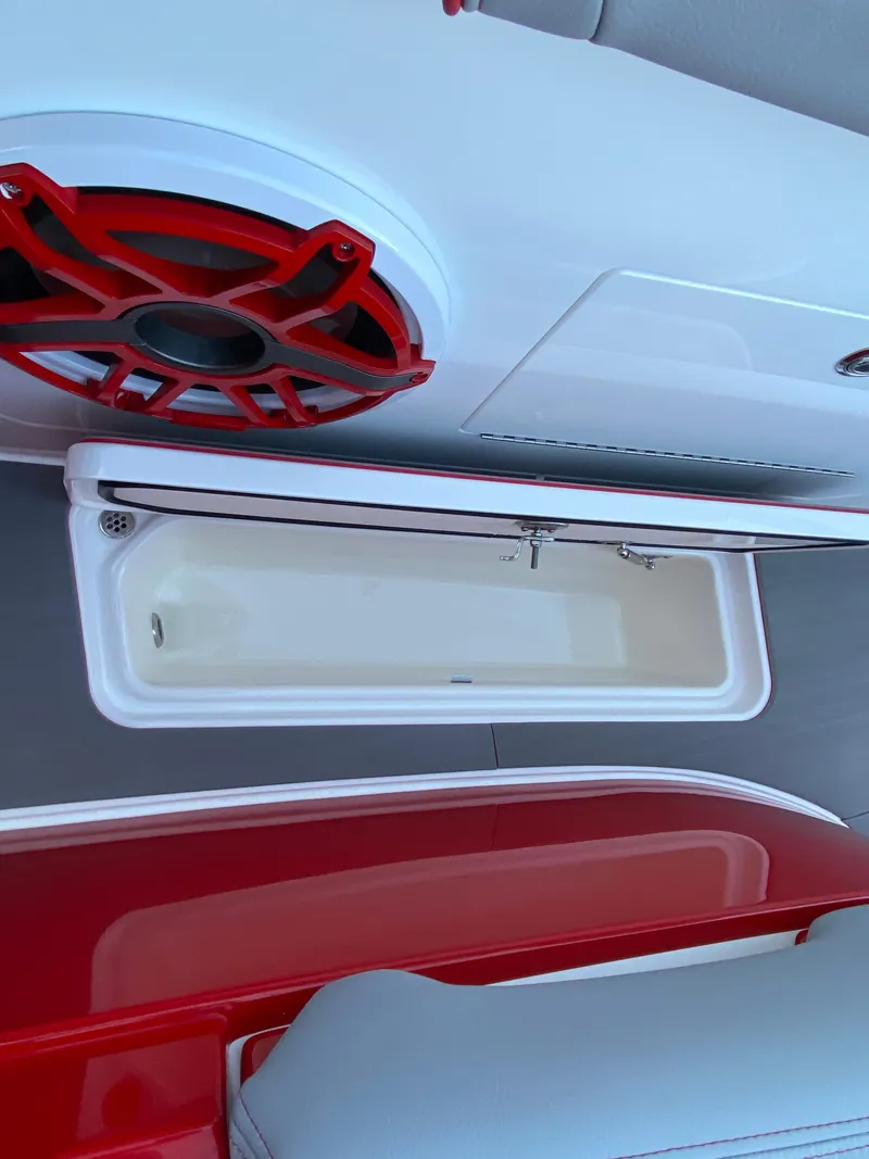 Slide: The Image of 2024 Fountain 38 SCX boat interior with red speaker and storage compartment. - 37