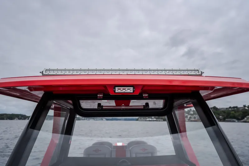 Slide: The Image of Red 2024 Fountain 38 SCX boat roof with LED light bar on a cloudy day. - 80