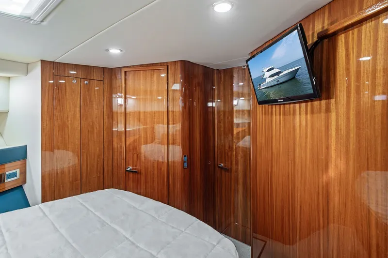 Slide: The Image of Luxurious 2016 Maritimo M58 yacht interior with wood paneling and mounted TV. - 48