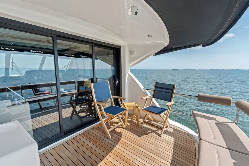 Slide: The Image of Luxurious 2016 Maritimo M58 yacht deck with seating, overlooking serene ocean view. - 17