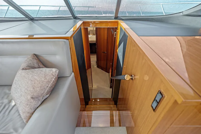 Slide: The Image of Interior view of 2016 Maritimo M58 yacht, featuring elegant wood finishes and modern design. - 37
