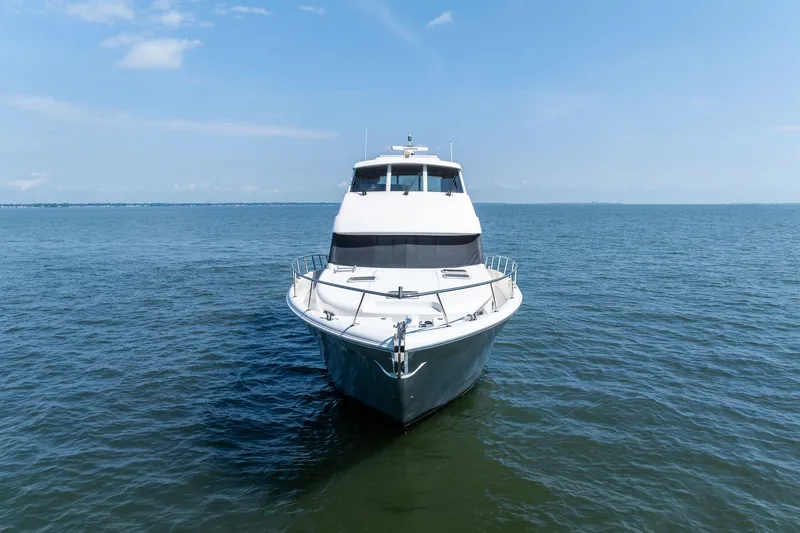 Slide: The Image of 2016 Maritimo M58 yacht on open water under clear blue sky. - 2