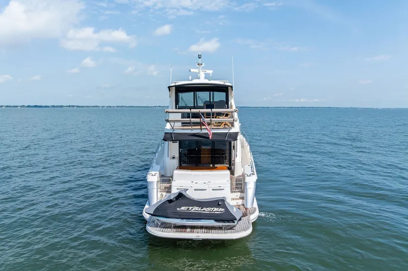 Slide: The Image of 2016 Maritimo M58 yacht on open water with jet ski on platform. - 5