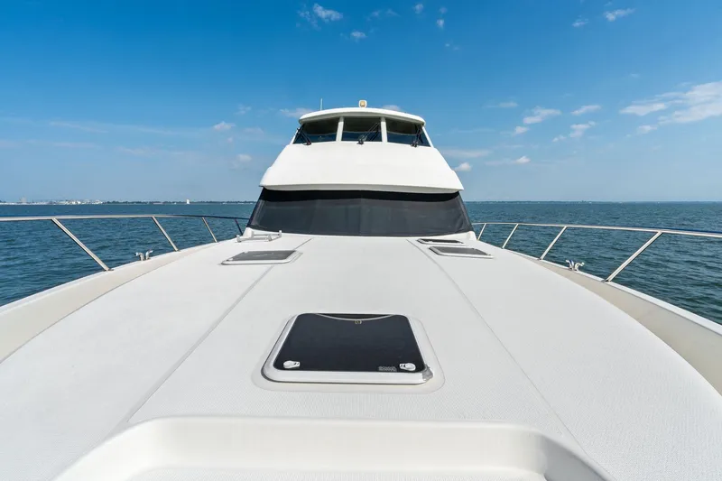 Slide: The Image of 2016 Maritimo M58 yacht on open water under clear blue sky. - 14