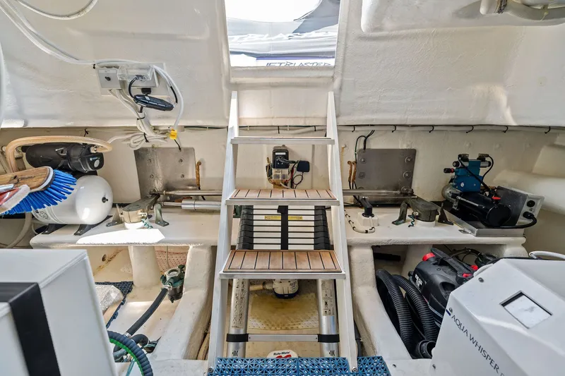 Slide: The Image of Engine room of 2016 Maritimo M58 yacht with equipment and wooden steps. - 61
