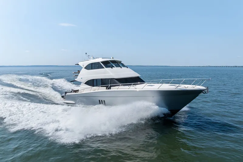 Slide: The Image of 2016 Maritimo M58 yacht cruising on open water, creating a dynamic wake. - 64
