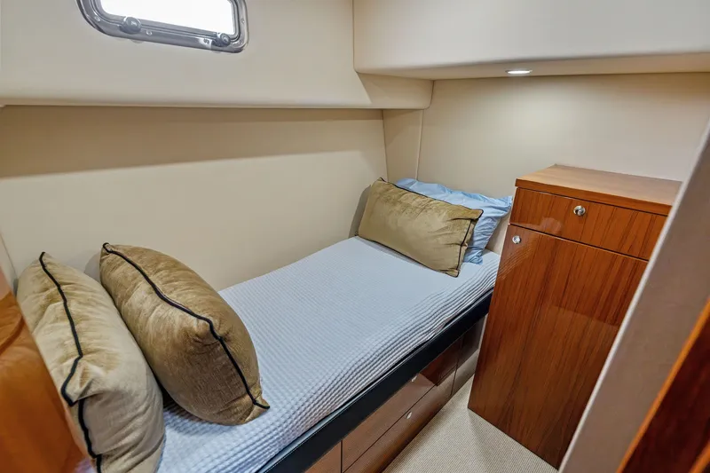 Slide: The Image of Cozy cabin interior of 2016 Maritimo M58 yacht with single bed and wooden cabinetry. - 52
