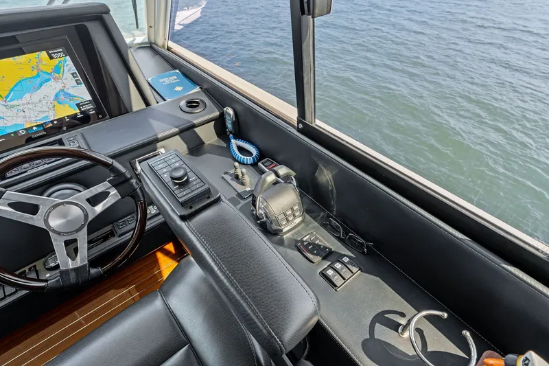 Slide: The Image of Helm of 2016 Maritimo M58 yacht with navigation controls and sea view. - 25