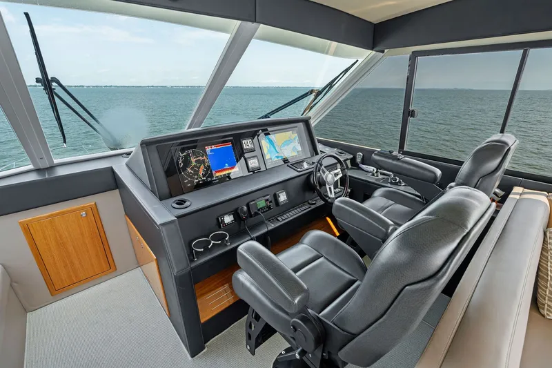 Slide: The Image of Helm of 2016 Maritimo M58 yacht with navigation equipment and leather seating. - 24