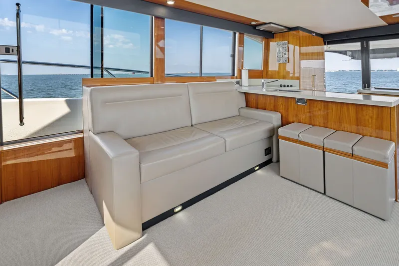 Slide: The Image of Luxurious interior of 2016 Maritimo M58 yacht with beige seating and ocean view. - 32