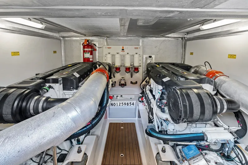 Slide: The Image of Engine room of a 2016 Maritimo M58 yacht, featuring dual engines and safety equipment. - 62