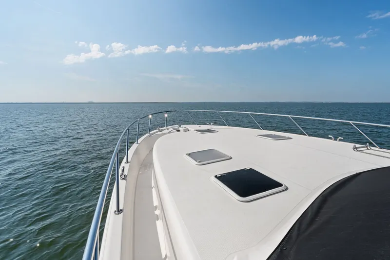Slide: The Image of 2016 Maritimo M58 yacht deck overlooking calm ocean under clear blue sky. - 13